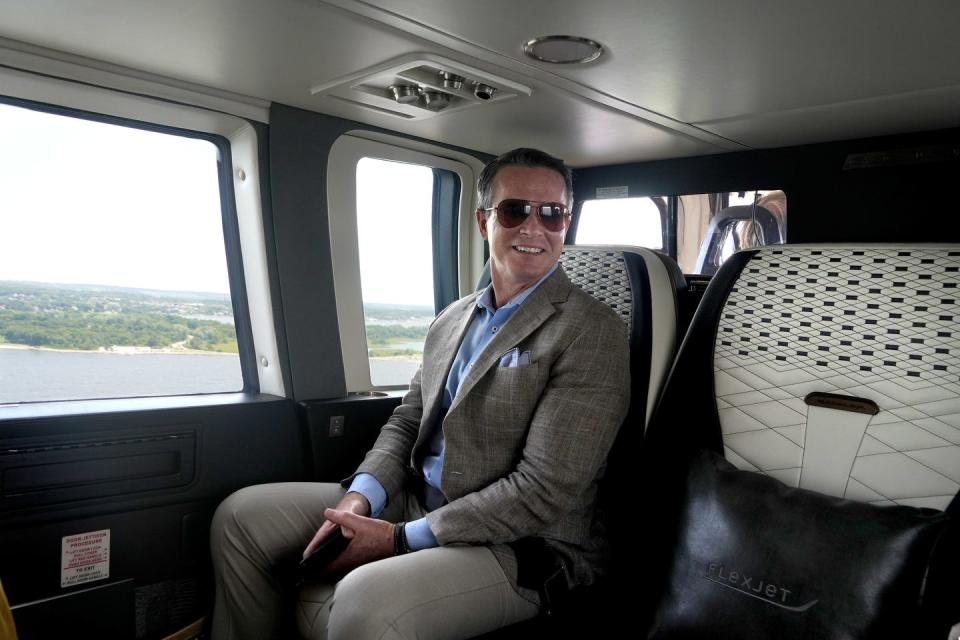 Eli Flint, president of the Flexjet helicopter division, sits in the leather seat cabin of the Flexjet Sikorsky S-76.  The interior cabin design was modeled after the interior of a Bentley automobile. 