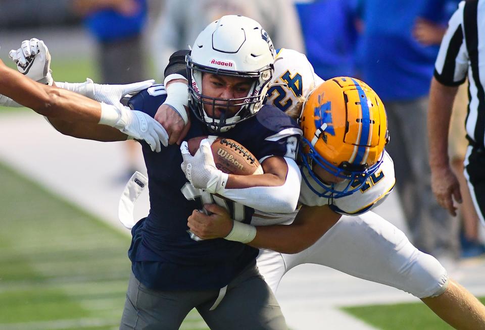 Dayre Senft (20) of Chambersburg is tackled by Waynesboro's Andrew Florek (42).Chambersburg defeated Waynesboro 40-20, Friday, September 8, 2023. (Markell DeLoatch, For GameTimePa)