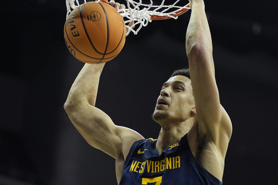 West Virginia center Jesse Edwards dunks the ball during the first half of an NCAA college basketball game against Cincinnati Tuesday, March 12, 2024, in Kansas City, Mo. (AP Photo/Charlie Riedel)