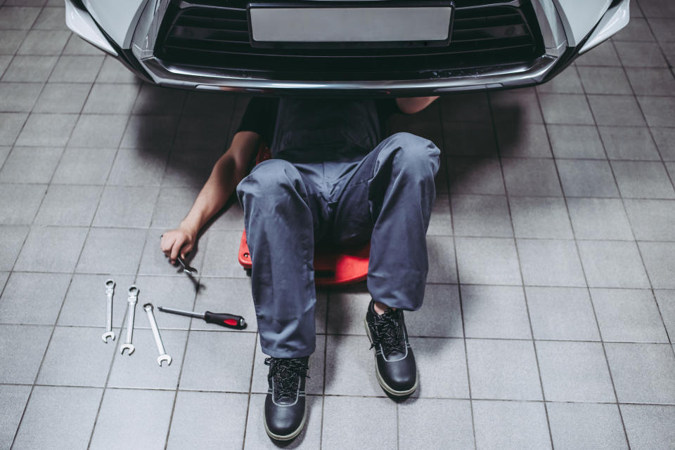 mechanic underneath a car working