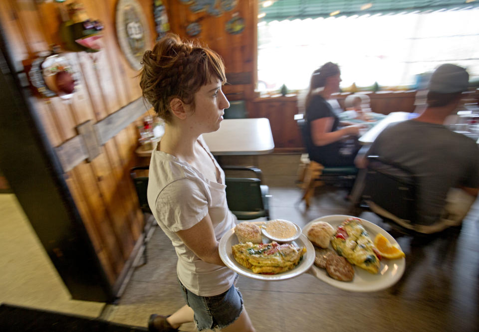 Server Brittany Hester runs food out from the kitchen at the Home grown restaurant, Tuesday, Oct. 22, 2013, in Atlanta. Home grown offers locally sourced Southern dishes for breakfast and lunch in a quirky, no-frills setting that feels comfortable no matter who you are. (AP Photo/David Goldman) (AP Photo/David Goldman)