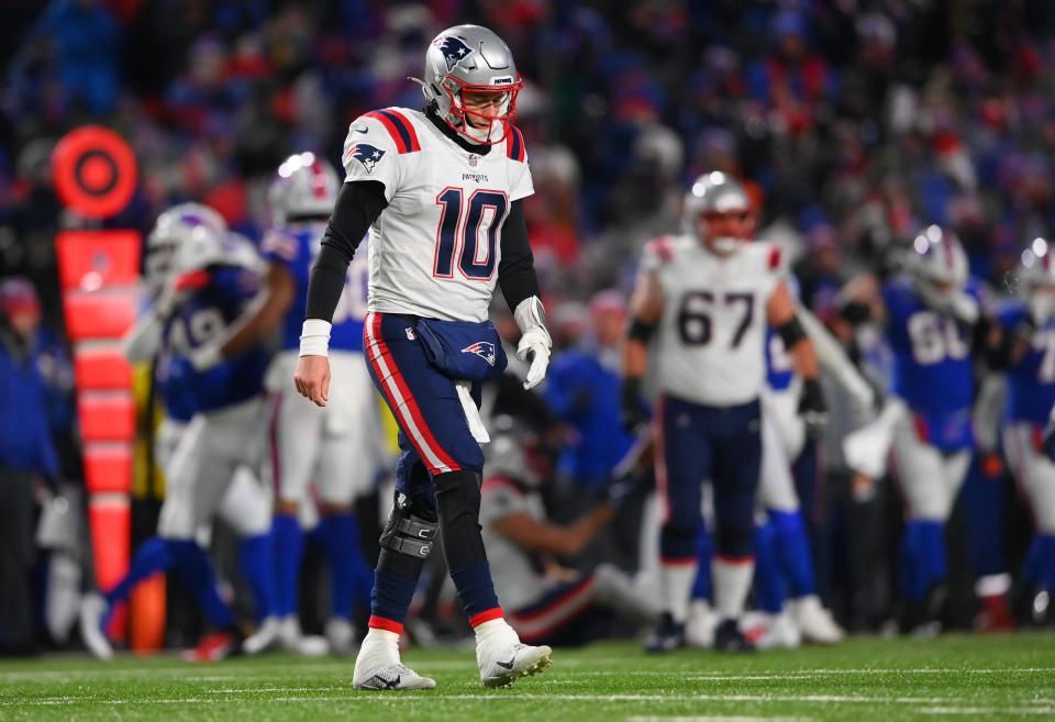 New England Patriots quarterback Mac Jones reacts after throwing an interception during the third quarter of the AFC Wild Card playoff game against the Buffalo Bills at Highmark Stadium in Orchard Park, New York, on Saturday, Jan. 15, 2022.