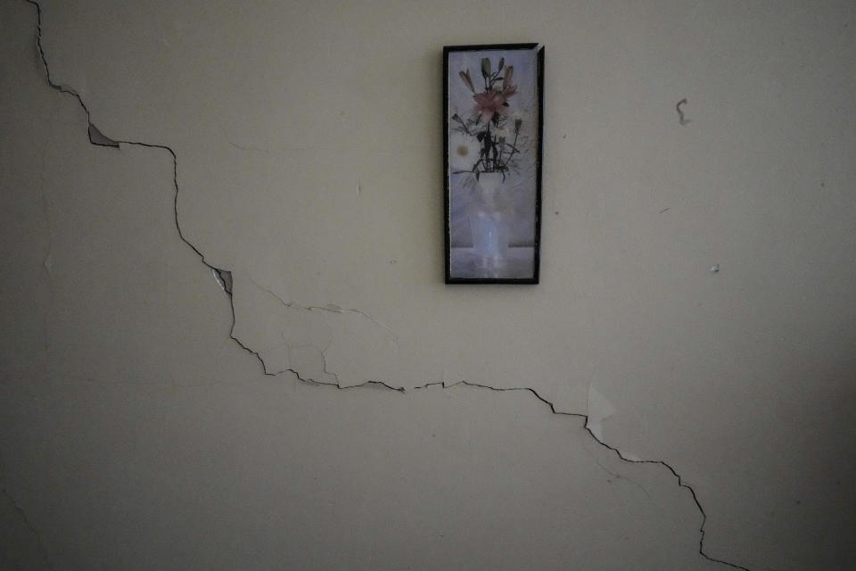 A crack runs through a wall alongside a painting hanging in Rev. David Gonzalez's apartment, located next to the Calvary Baptist Church building, damaged by an explosion that devastated the next door Hotel Saratoga in Old Havana, Cuba, Wednesday, May 11, 2022. Parts of the upper floors have collapsed at the building that houses not only the church but a seminary and the denomination's headquarters for western Cuba. (AP Photo/Ramon Espinosa)