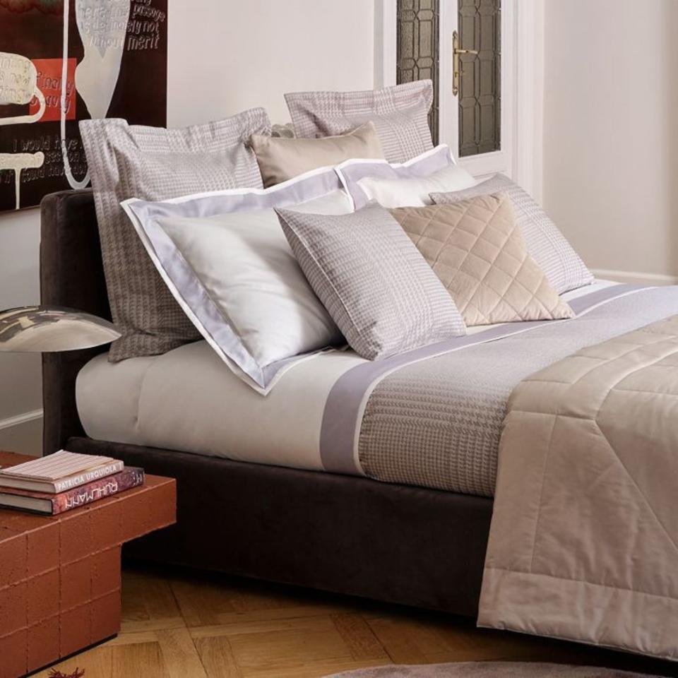 Frette Simple Cotton Quilted Bedding on a bed.