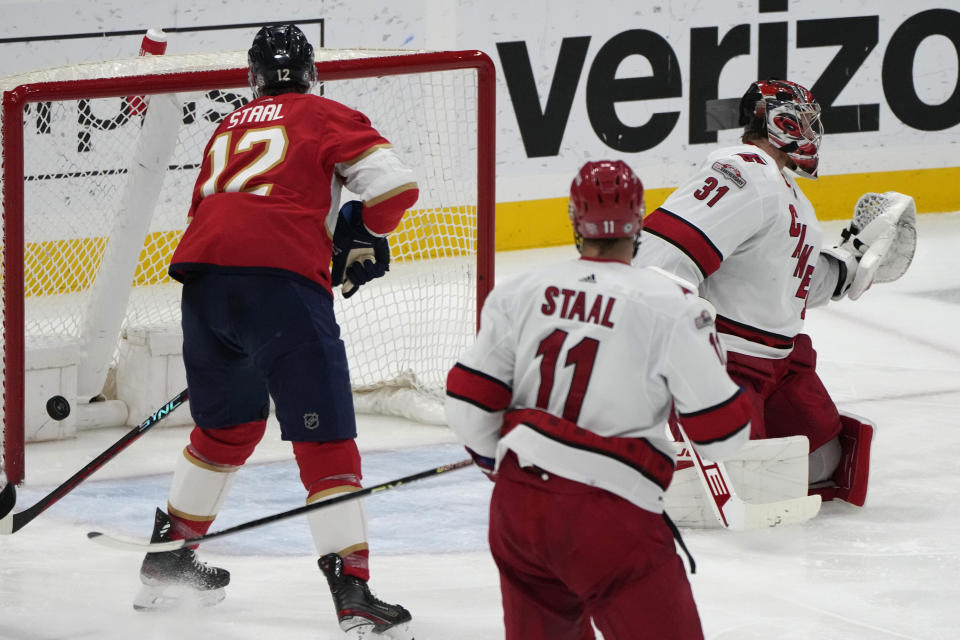 The puck gets past Carolina Hurricanes goaltender Frederik Andersen (31) for a goal by Florida Panthers left wing Ryan Lomberg (not shown) during the third period of an NHL hockey game, Thursday, April 13, 2023, in Sunrise, Fla. (AP Photo/Lynne Sladky)