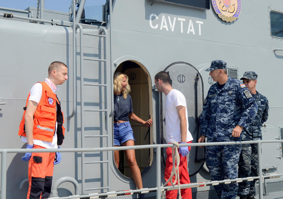 The flight attendant leaves the Croatian Coast Guard vessel “Cavtat” in Pula, Croatia after being rescued. Source: Reuters