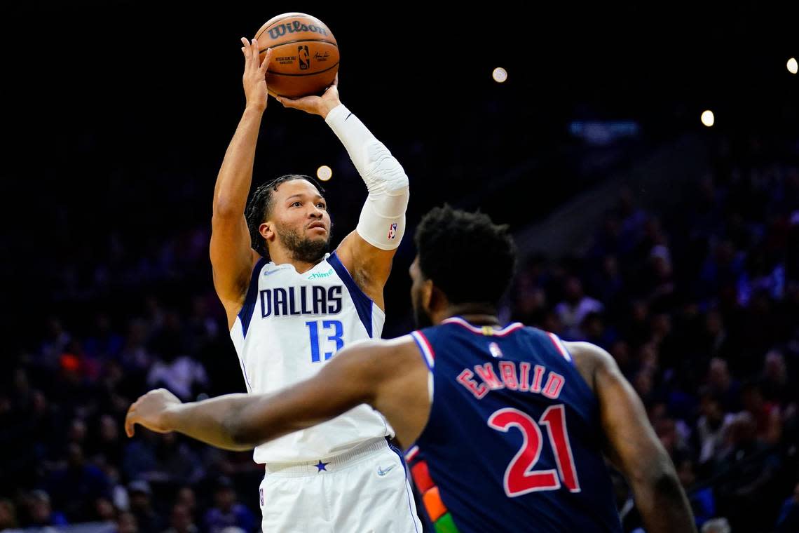 Dallas Mavericks’ Jalen Brunson, left, goes up for a shot against Philadelphia 76ers’ Joel Embiid during the first half of an NBA basketball game on March 18, 2022, in Philadelphia.