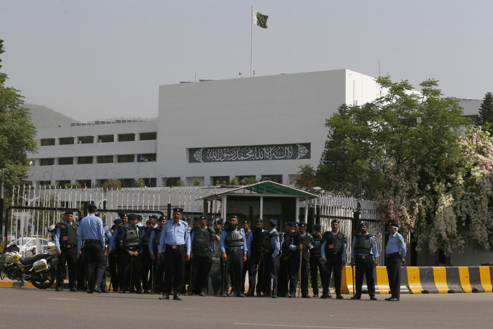Police officers stand guard to ensure security outside the National Assembly, in Islamabad, Pakistan, Saturday, April 9, 2022. Pakistan's embattled prime minister faces a tough no-confidence vote Saturday waged by his political opposition, which says it has the numbers to defeat him. (AP Photo/Anjum Naveed)