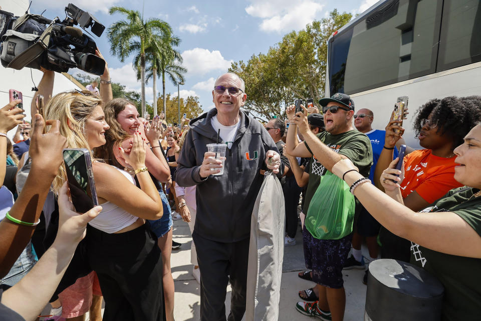 Miami men's NCAA college basketball head coach Jim Larrañaga greets fans outside the University of Miami's Watsco Center as the team prepares to depart for the Final Four in Houston, Wednesday, March 29, 2023. (Al Diaz/Miami Herald via AP)