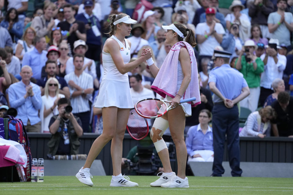 Kazakhstan's Elena Rybakina, left, greets Alize Cornet of France after beating her in a women's singles match on day four of the Wimbledon tennis championships in London, Thursday, July 6, 2023. (AP Photo/Kirsty Wigglesworth)