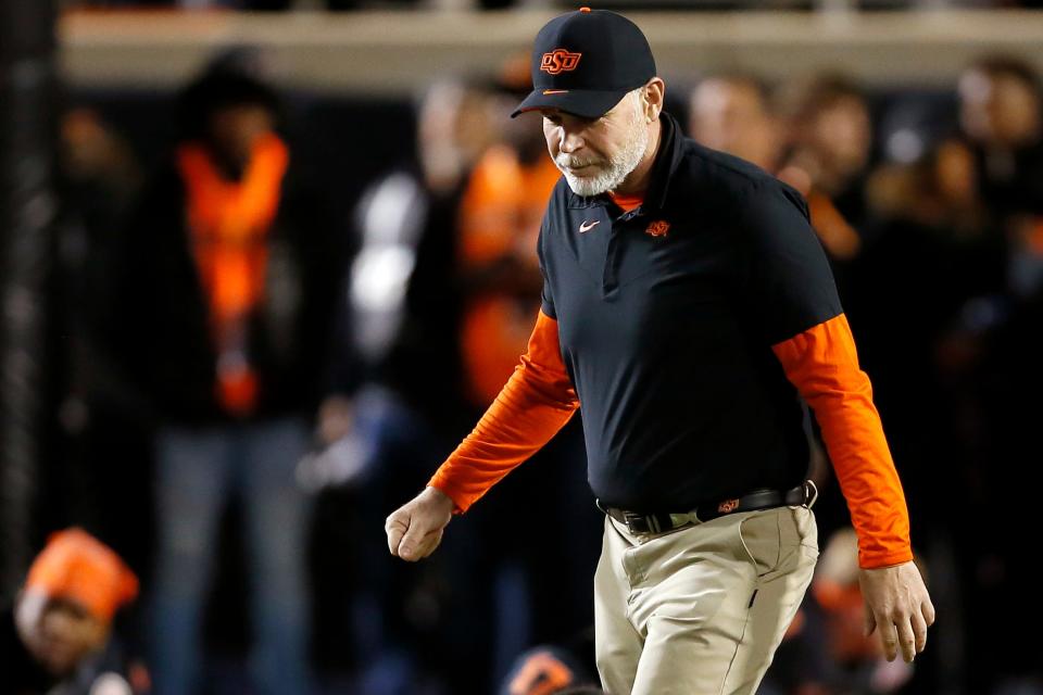 Jim Knowles, OSU defensive coordinator, walks on the field before a Bedlam college football game between the Oklahoma State University Cowboys (OSU) and the University of Oklahoma Sooners (OU) at Boone Pickens Stadium in Stillwater, Okla., Saturday, Nov. 27, 2021. Oklahoma State won 37-33. 