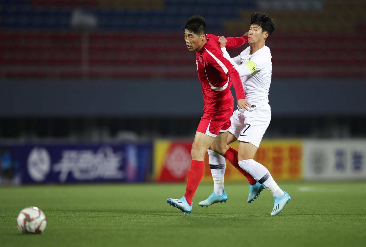 A handout photo made available by the Korea Football Association (KFA) of Son Heung-min (R, in white) of South Korea in action during their World Cup qualifying match against North Korea: EPA