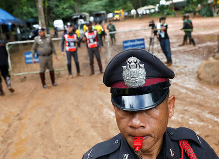 Police officers are seen near the Tham Luang cave complex, as a search for members of an under-16 soccer team and their coach continues, in the northern province of Chiang Rai, Thailand, June 29, 2018. REUTERS/Soe Zeya Tun