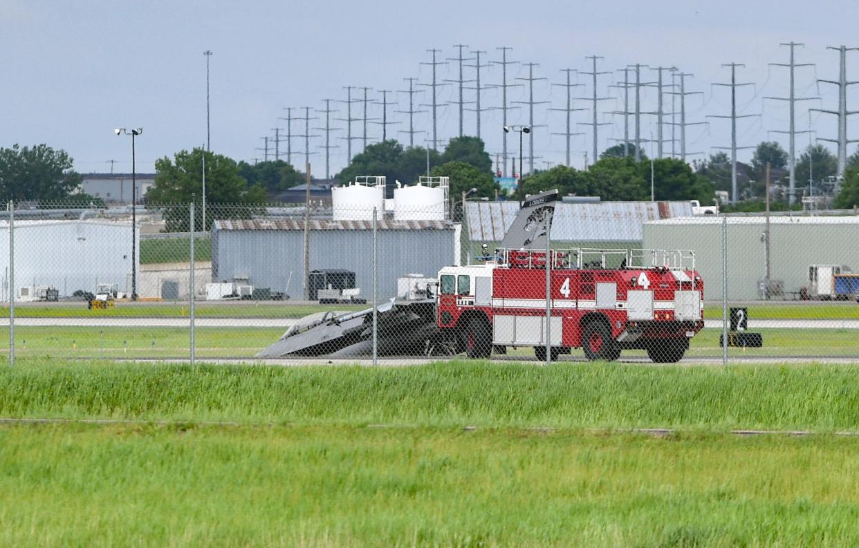 Emergency vehicles park near a military plane that appears to have gone off the runway on Tuesday, May 31, 2022, at the Sioux Falls Regional Airport.