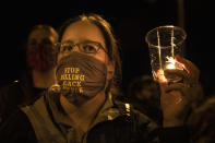 People gather for Kevin Peterson Jr., who was killed in Thursday's shooting with police involved, at a candlelight vigil in Vancouver, Wash., Friday, Oct. 30, 2020. The Clark County Sheriff's office has not released any details on the Thursday evening shooting in Hazel Dell, but a man told The Oregonian/OregonLive that his 21-year-old son was fatally shot by police. (AP Photo/Paula Bronstein)