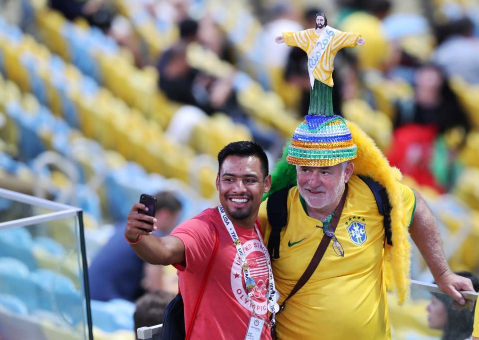 <p>A volunteer takes a selfie with a fan before the opening ceremony of the 2016 Summer Olympics in Rio de Janeiro, Brazil, Friday, Aug. 5, 2016. (AP Photo/Lee Jin-man) </p>