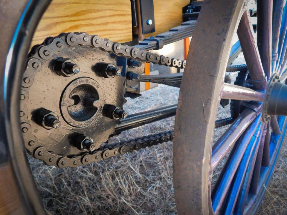 A close-up of a drive chain and sprocket on the Grimm brothers' 1907 International Harvester high-wheeler auto buggy is shown. The drive chain is from the original era of the vehicle.