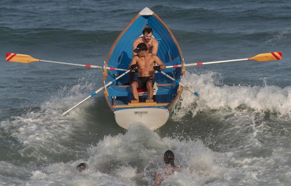 Surf City Charlie Osborne and Mark Dileo head out in the Miles Double Row competition. First night events in 2021 LBI Beach Patrol Islands Tournament in Surf City, NJ on August 6, 2021. 