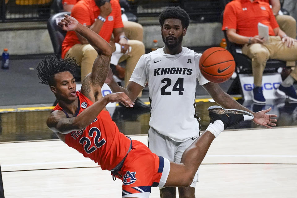 Auburn guard Allen Flanigan (22) saves the ball from going out of bounds in front of Central Florida guard Dre Fuller Jr. (24) during the second half of an NCAA college basketball game, Monday, Nov. 30, 2020, in Orlando, Fla. (AP Photo/John Raoux)