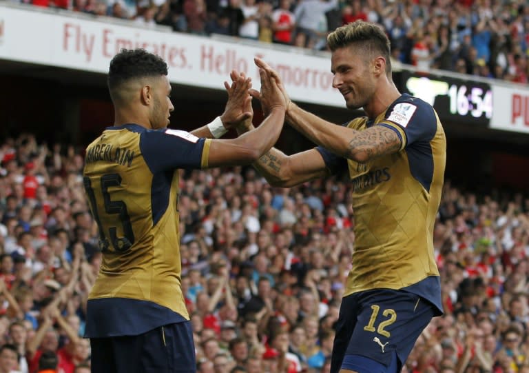 Arsenal striker Alex Oxlade-Chamberlain (L) celebrates with teammate Olivier Giroud after scoring during the pre-season friendly against Lyon at The Emirates Stadium on July 25, 2015