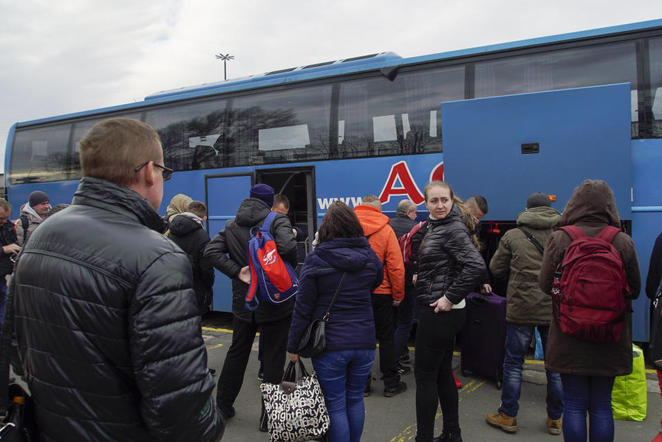 Ukrainians disembark the Kharkiv-Warsaw bus in Warsaw, Poland, on March 10, 2019. As Ukrainians prepare to go to the polls in a presidential election March 31, millions have already voted with their feet to leave the country, seemingly mired by corruption, poverty and conflict. (AP Photo/Mstyslav Chernov)