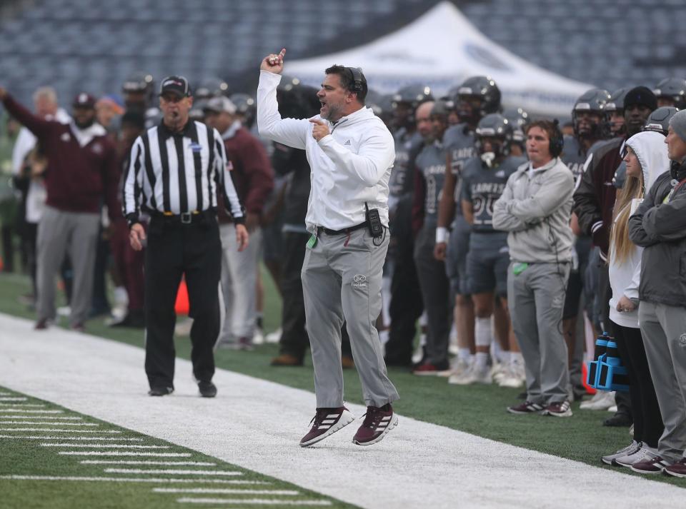 Benedictine football coach Danny Britt calls in a play from the sideline during the GHSA Class 4A state championship game against Carver-Columbus on Dec. 10, 2021 at Center Parc Stadium in Atlanta.