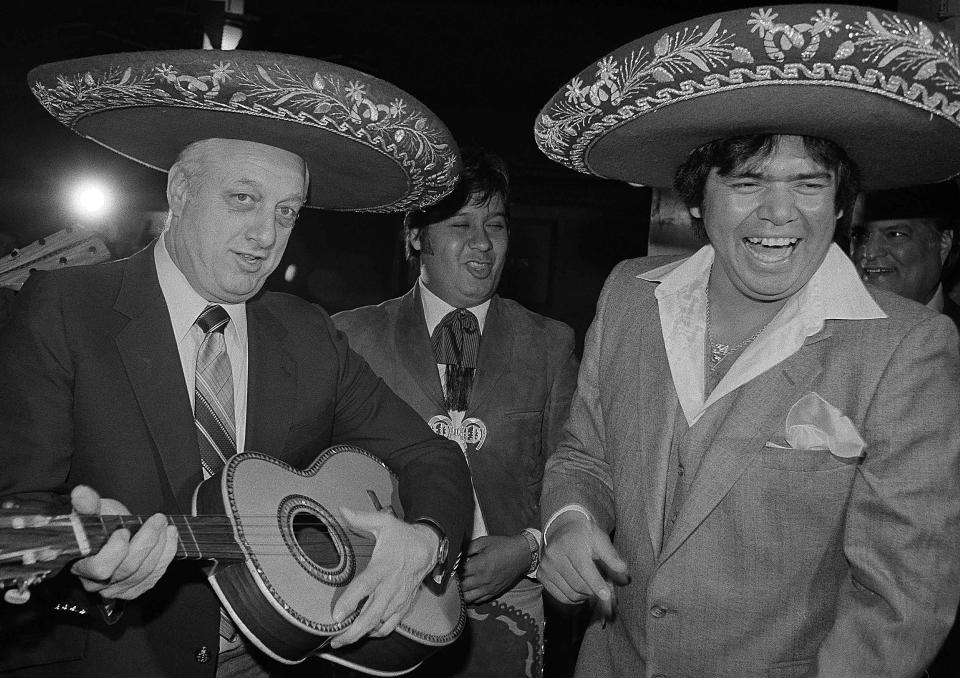 FILE - In this Dec. 3, 1981, file photo, Los Angeles Dodgers' Manager Tommy Lasorda, left, and pitcher Fernando Valenzuela wear sombrero's in Los Angeles. The Dodgers needed a strike interrupted season and a pitching sensation named Fernando Valenzuela to win a championship in 1981. More important for the Dodgers, perhaps, is that they found a way that year to connect with Hispanic fans who nearly four decades later are still loyal supporters of the team. Author Jason Turbow tells PodcastOne Sports Now that the season was significant in many ways for the Dodgers, something he details in his new book ``They Bled Blue,'' a recap of a season like no other. (AP Photo/Wally Fong, File)