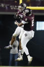 Texas A&M defensive back Jaylon Jones (17) reacts with teammate DeMarvin Leal (8) after intercepting a pass from LSU during the first half of an NCAA college football game, Saturday, Nov. 28, 2020, in College Station, Texas. (AP Photo/Sam Craft)