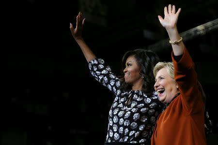 First lady Michelle Obama and U.S. Democratic presidential candidate Hillary Clinton wave after a campaign rally in Winston-Salem, North Carolina, U.S. October 27, 2016. REUTERS/Carlos Barria