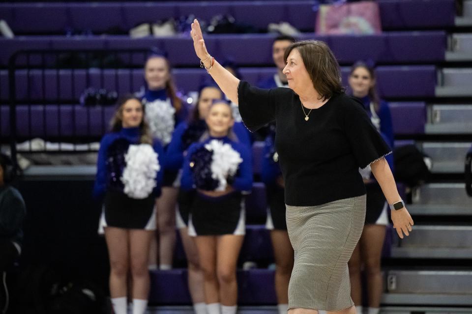 Sherry Levin waves to the crowd during Saturday's ceremony retiring the numbers of former Holy Cross female basketball players.