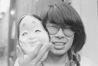 Japanese fashion designer Kenzo Takada holds a theatrical mask. He created the designer fashion label Kenzo and retired in 1999. (Photo by Pierre Vauthey/Sygma/Sygma via Getty Images)