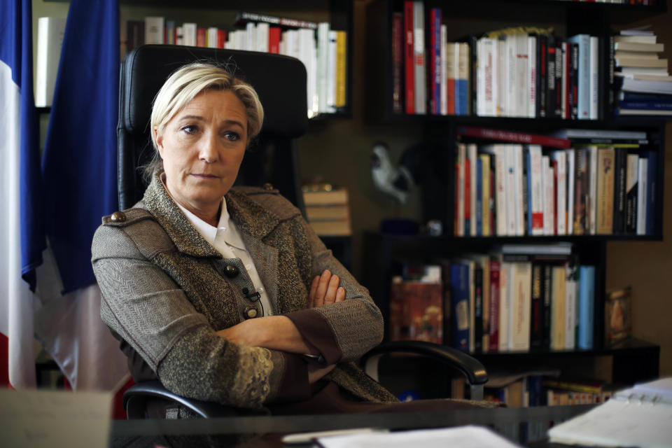 National Front leader Marine le Pen folds her arms during an interview with the Associated Press at the party headquarters in Nanterre outside Paris, Monday, March 3, 2014. The leader of France’s far-right National Front is looking to apply some basic principles of her anti-immigrant party in towns where it is victorious in municipal elections this month, like refusing precious public funds for religious associations. A leading euro-skeptic, Le Pen is also looking to boost her party’s strength in European Parliament elections in May. (AP Photo/Jerome Delay)