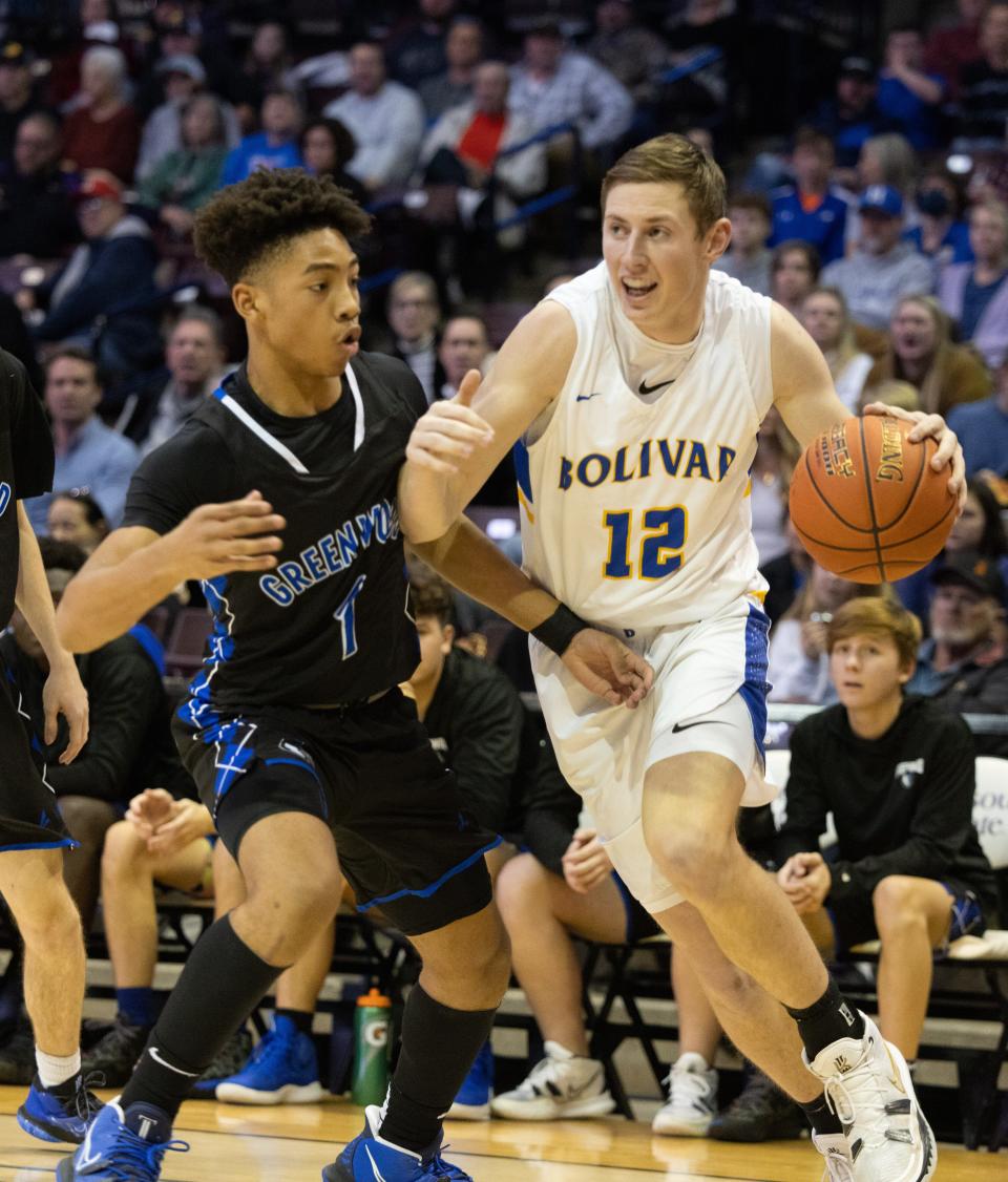 Bolivar’s Kyle Pock drives around Greenwood’s Tanner Jones during the semifinal round of the gold division at the Blue and Gold Tournament on December 29, 2021.