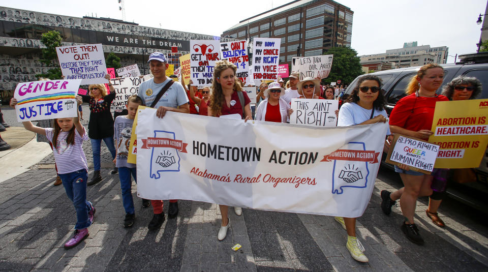 Protesters for women's rights march to the Alabama Capitol to protest a law passed last week making abortion a felony in nearly all cases with no exceptions for cases of rape or incest, Sunday, May 19, 2019, in Montgomery, Ala. (AP Photo/Butch Dill)