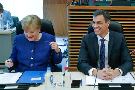 German Chancellor Angela Merkel and Spanish Prime Minister Pedro Sanchez attend an emergency European Union leaders summit on immigration at the EU Commission headquarters in Brussels, Belgium June 24, 2018. REUTERS/Yves Herman/Pool