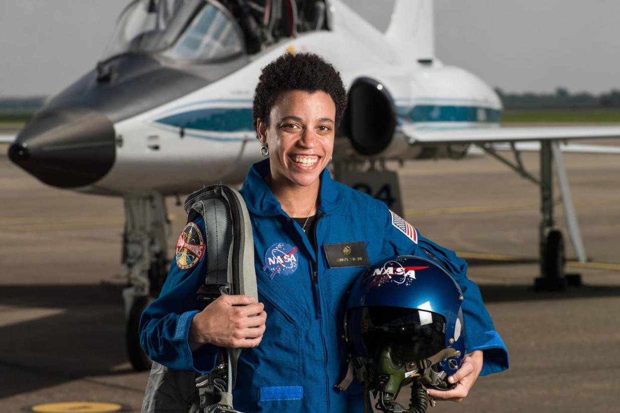 Jessica Watkins, the first Black woman set to be a part of an International Space Station crew, displays Black joy as she poses for a picture in front of a plane. (NASA)