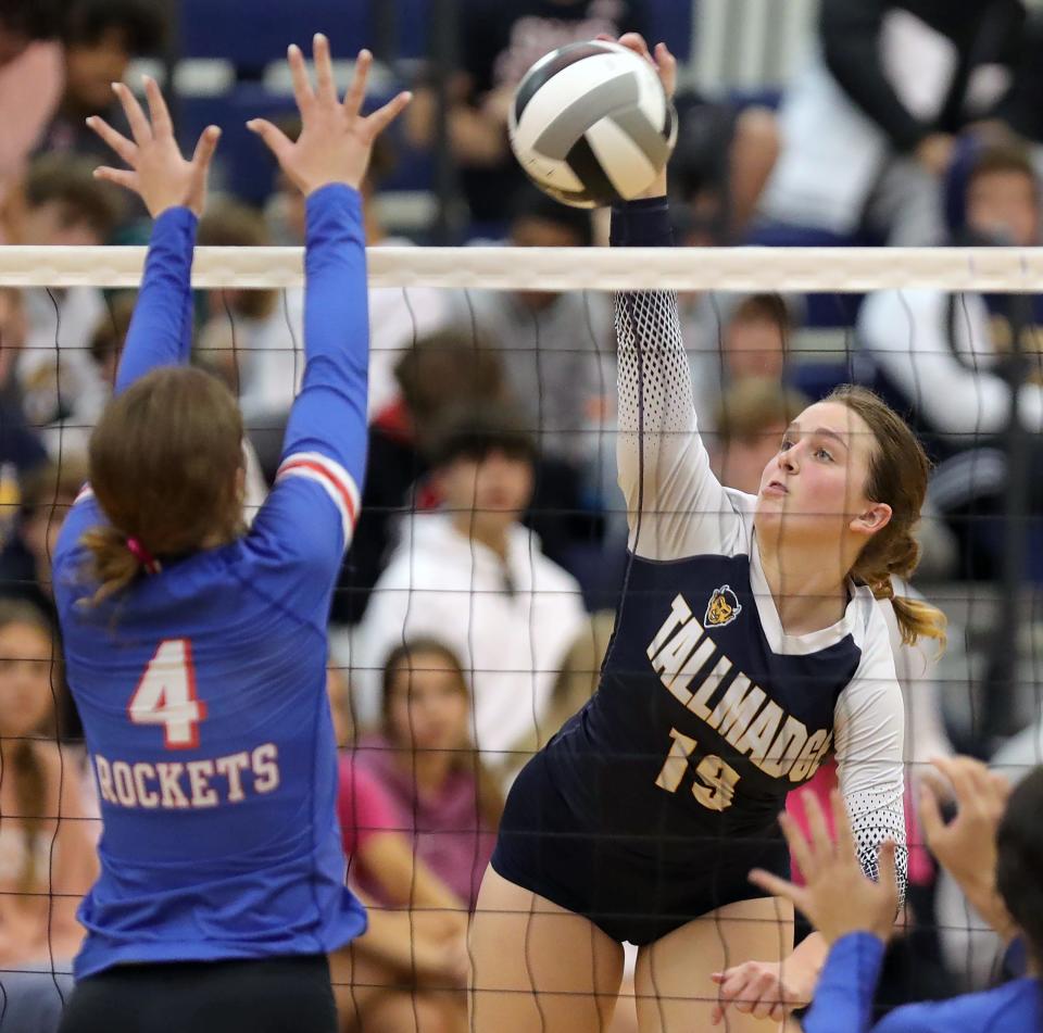 Tallmadge senior Hannah Eyre spikes the ball past Bay senior Lauren Maxwell during the third set of a Division II district semifinal volleyball match, Wednesday, Oct. 26, 2022, in Tallmadge, Ohio.