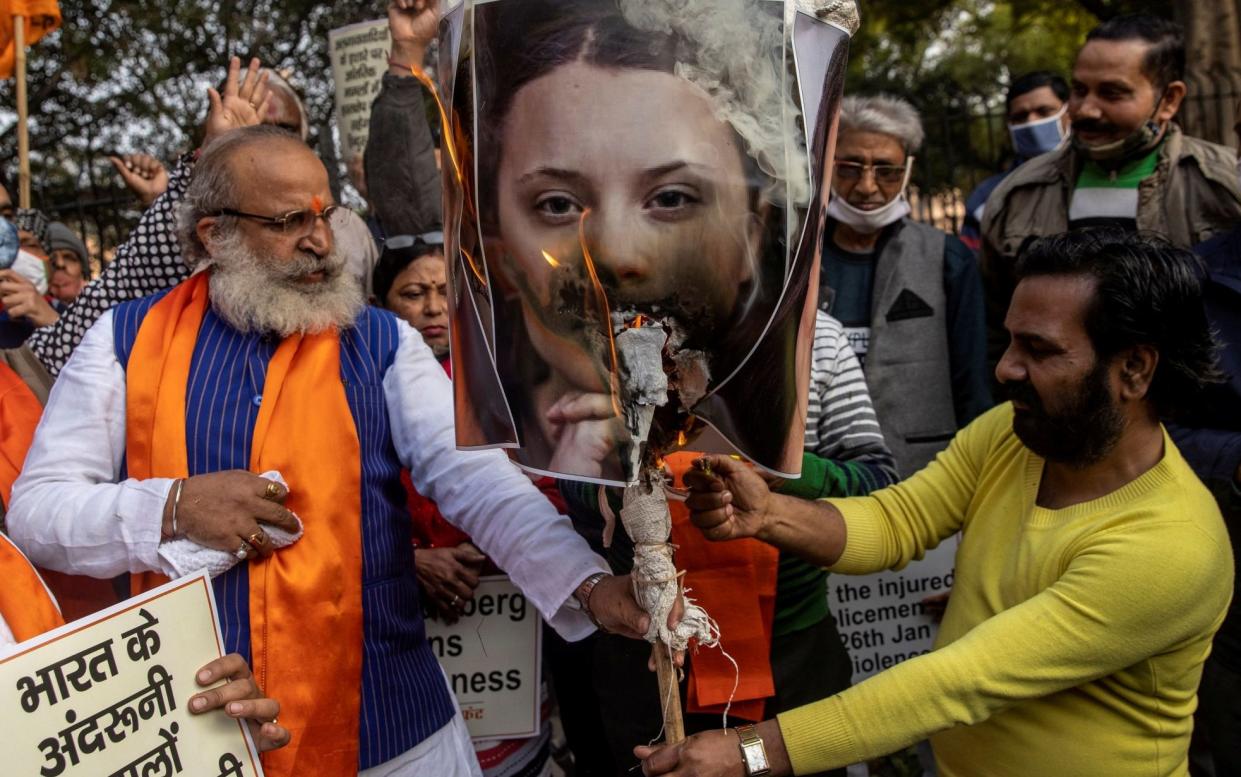 Activists from United Hindu Front burn an effigy depicting climate change activist Greta Thunberg - REUTERS/Danish Siddiqui TPX