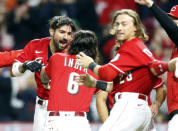 Cincinnati Reds Nick Castellanos, left, celebrates with teammates Jonathan India, center, and TJ Friedl after hitting a home run against Washington Nationals pitcher Patrick Murphy to win a baseball game during the ninth inning in Cincinnati, Saturday, Sept. 25, 2021. (AP Photo/Paul Vernon)