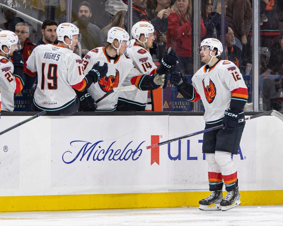 Ty Kartye fist bumps teammates after his goal in a 4-2 win over the San Diego Gulls on Sunday, Jan. 22, 2023 at Acrisure Arena.