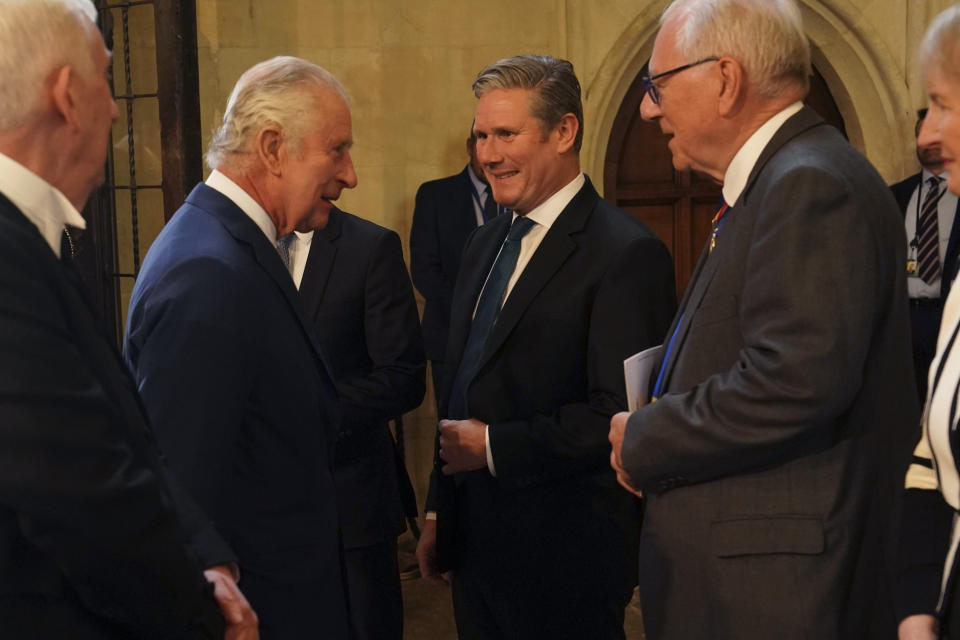 Britain's King Charles III, second left, speaks with Labour leader Keir Starmer, during a visit to Westminster Hall at the Palace of Westminster to attend a reception ahead of the coronation, in London, Tuesday May 2, 2023. (Arthur Edwards/Pool Photo via AP)