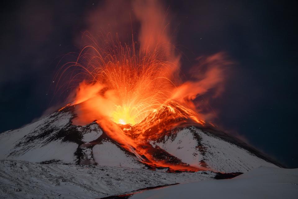 Lava erupts from snow-covered Mt Etna volcano, Sicily, Italy, early Saturday, Nov. 25, 2023.