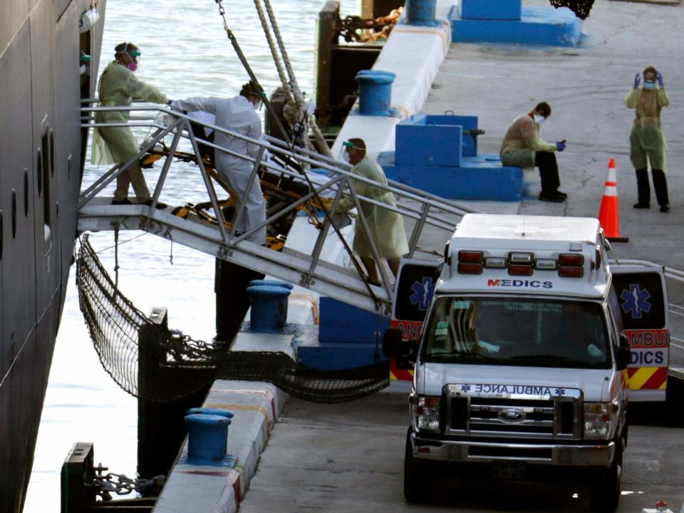 A person on a stretcher is removed from Carnival's Holland America cruise ship Zaandam at Port Everglades in Fort Lauderdale, Florida, during the new coronavirus pandemic, 2 April 2020: Lynne Sladky/AP