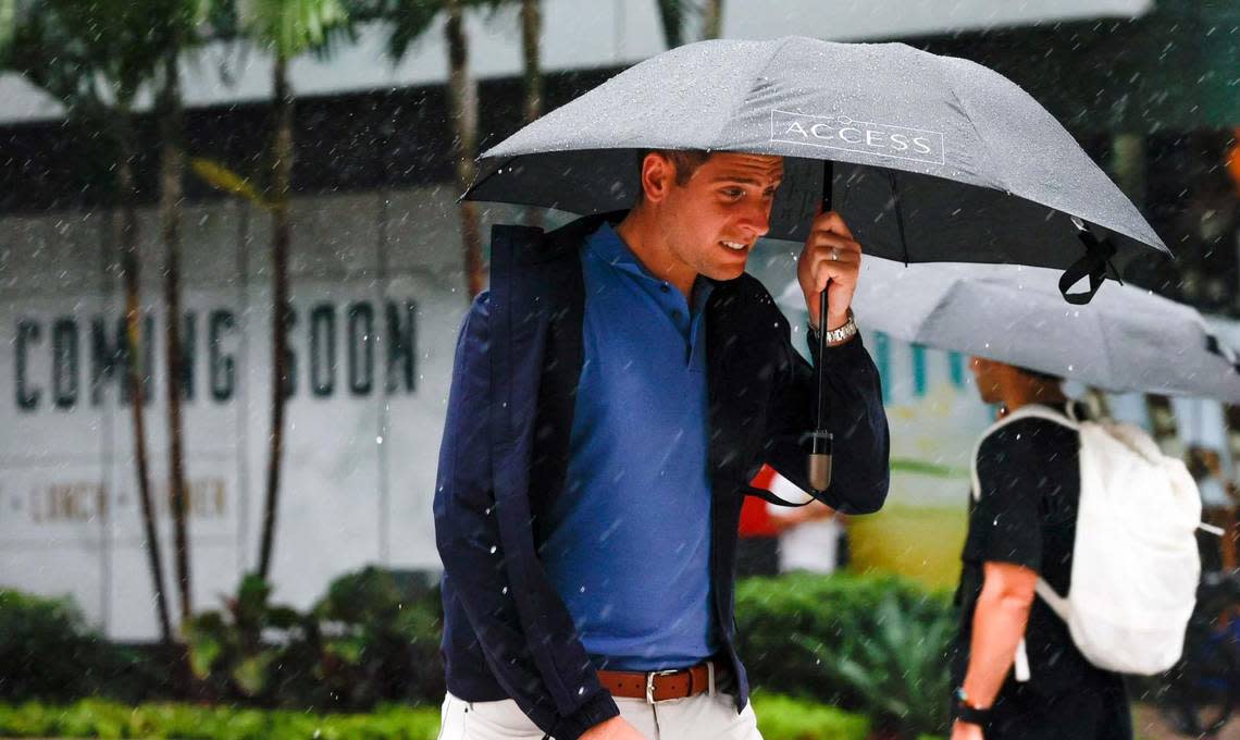 Pedestrians brace against the rain and wind with umbrellas in hand as they cross the street at Brickell City Center in Miami, Florida, on Tuesday, September 27, 2022. All of South Florida is now in alert for Hurricane Ian’s tropical storm-force winds. Daniel Varela/dvarela@miamiherald.com