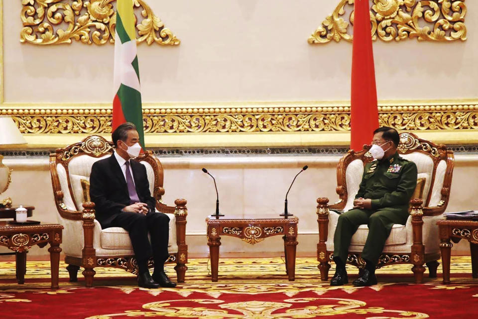 Myanmar's Army Commander Senior Gen. Min Aung Hlaing, right, talks with Chinese Foreign Minister Wang Yi during their meeting in Naypyitaw, Myanmar, Tuesday, Jan. 12, 2021. (Myanmar Military Information Team via AP)