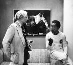 FILE - In this July 26, 1977 file photo, surrealist artist Andy Warhol speaks with Brazil's soccer player Pele about a portrait after Warhol was commissioned to make a series of portraits of athletic stars in New York. On Oct. 23, 2020, the three-time World Cup winner Pelé turns 80 without a proper celebration amid the COVID-19 pandemic as he quarantines in his mansion in the beachfront city of Guarujá, where he has lived since the start of the pandemic. (AP Photo/Claudia Larson, File)