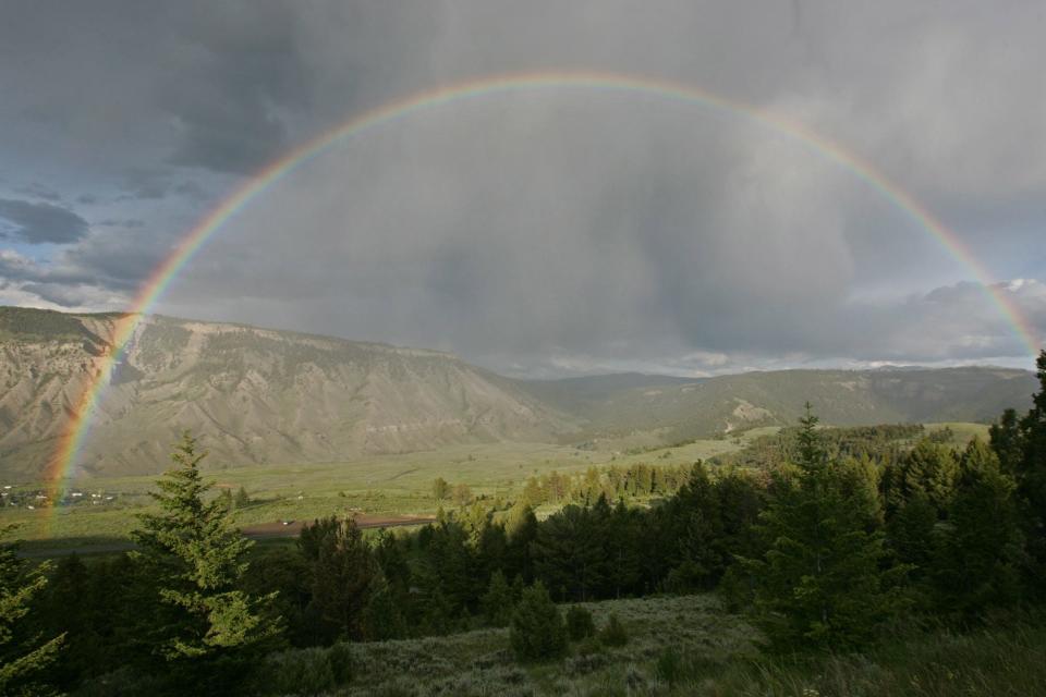 A rainbow stretches across the Mammoth Hot Springs area of Yellowstone National Park.