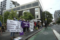 Protestors gather outside an immigration detention hotel where Serbia's Novak Djokovic is believed to stay, in Melbourne, Australia, Friday, Jan. 7, 2022. Locked in a dispute over his COVID-19 vaccination status, Djokovic was confined to the immigration detention hotel in Australia on Thursday as the No. 1 men's tennis player in the world awaited a court ruling on whether he can compete in the Australian Open later this month. (AP Photo/Hamish Blair)