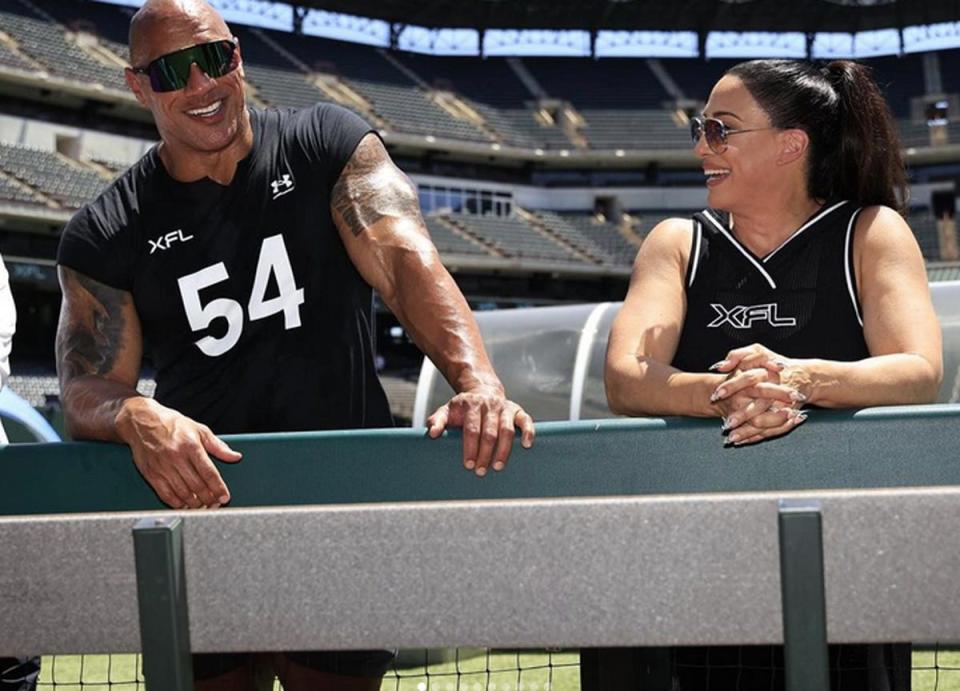 Dwayne Johnson and Dany Garcia in XFL jerseys