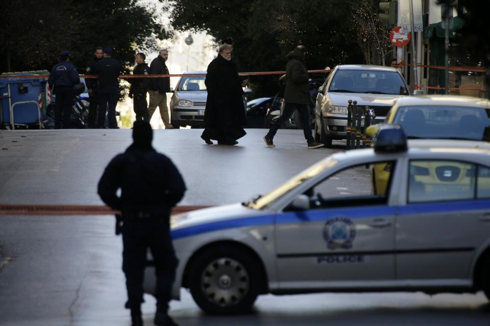 A Greek Orthodox priest arrives after an explosion at the Orthodox church of Agios Dionysios in the upscale Kolonaki area of Athens, Thursday, Dec. 27, 2018. Police in Greece say an officer has been injured in a small explosion outside a church in central Athens while responding to a call to investigate a suspicious package. (AP Photo/Thanassis Stavrakis)